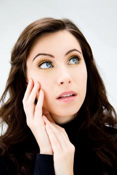 Face of a beautiful blue eyed brunette, isolated