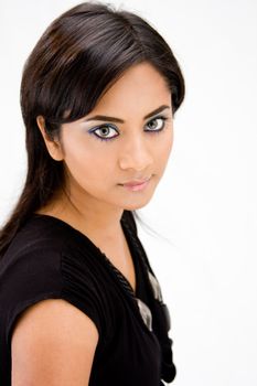 Face of a beautiful Hindi woman with subtle blue eye makeup and strong eyes, isolated