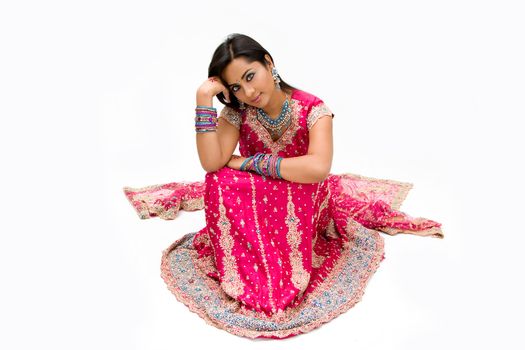 Beautiful Bengali bride in colorful dress day dreaming, isolated