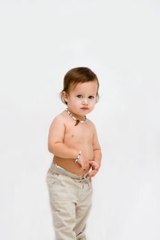 Cute unsure topless toddler boy with necklace, isolated