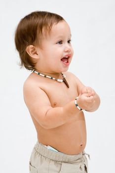 Cute and smiling topless toddler boy with necklace, isolated