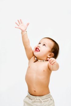 Cute topless toddler boy with necklace reaching for the sky, isolated
