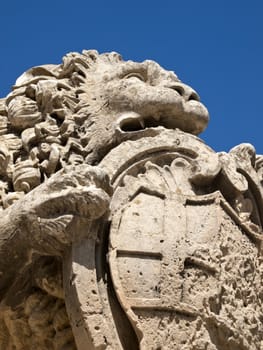One of the stone lions guarding the entrance gate to the medieval city of Mdina in Malta