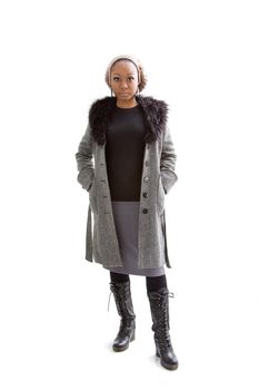 Beautiful African woman wearing gray winter wear, isolated