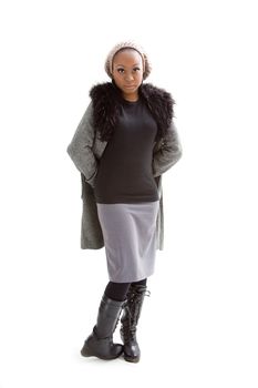 Beautiful African woman wearing gray winter wear, isolated