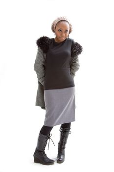 Beautiful African woman wearing gray winter wear, isolated