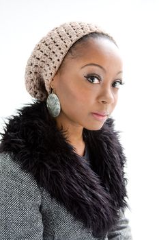 Face of a beautiful African woman wearing gray winter wear, isolated