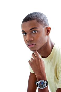 Sincere young African man in yellow shirt and hand under chin, isolated