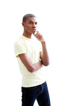 Casual young African man in yellow shirt with hand on chin thinking, isolated