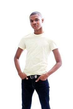 Casual young African man in yellow shirt and hands in pocket of jeans, isolated