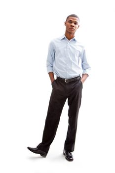 Young African business man standing relaxed and secure with hands in pocketand foot up, isolated