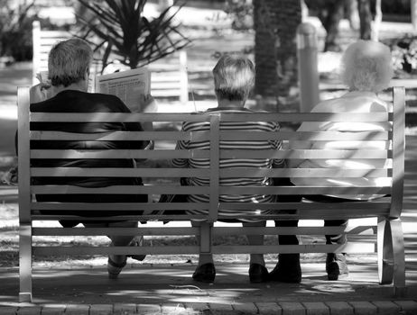Three old ladies sitting on a bench in a garden in Rabat

