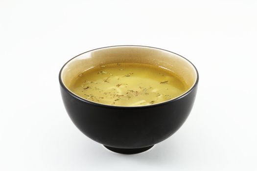 A bowl of hot soup served in an oriental bowl.