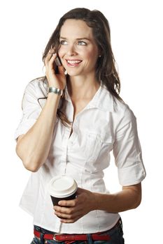 A beautiful happy woman talking on her cell phone and holding a take away coffee. Isolated over white.