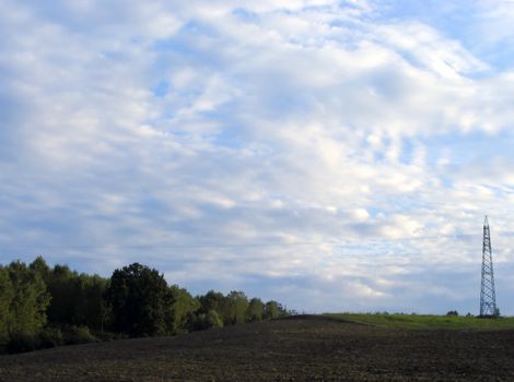 A field on the hill with a radio antenna