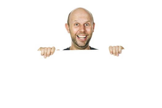 A great portrait of a happy and funny man peeking over a white wall or white sign smiling. Isolated over white.