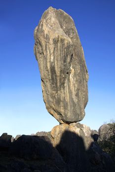 A massive lime stone boulder balancing on another rock