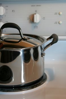 A closeup of a stainless steel roasting pot.
