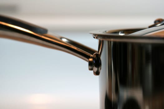 A closeup of a stainless steel pot handle.