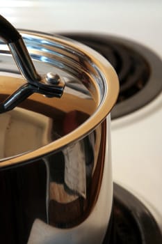 A closeup of a stainless steel pot lid.
