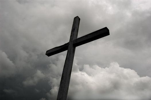rustic wooden cross against dramatic sky