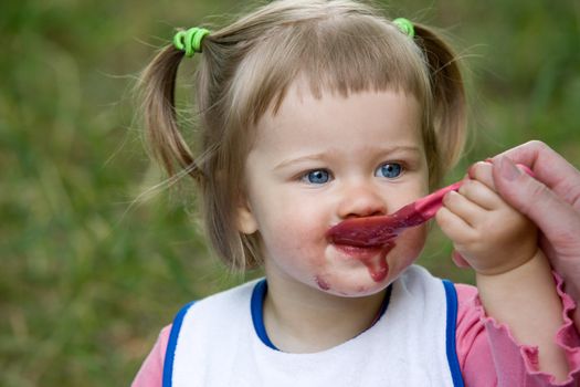 people series: little girl is eating fruit jam