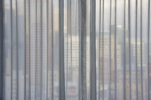 cityscape of San Francisco through white transparent window curtain, focus on curtain