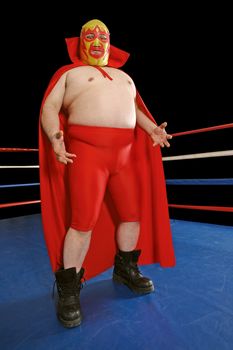 Photograph of a Mexican wrestler or Luchador standing in a wrestling ring.