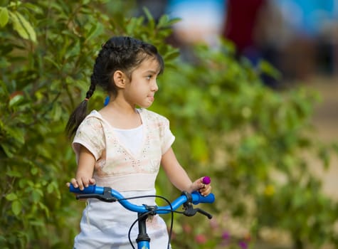 cute thai-indian girl sitting on her bike 