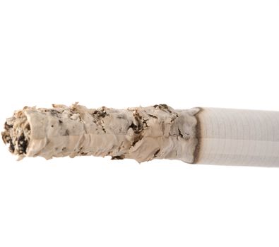 Smoldering cigarette is isolated on a white background.