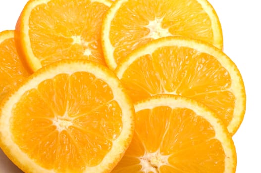 Segments of an orange a close up it is isolated on a white background.