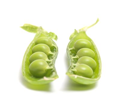 Two halves of a pod of peas on a white background.