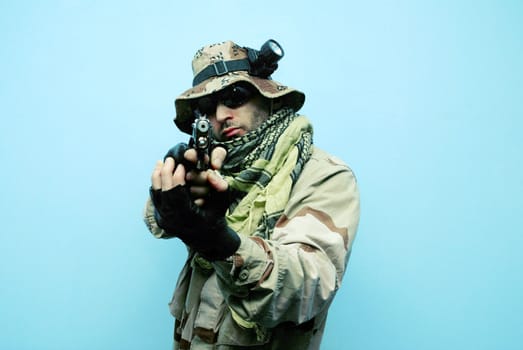 one soldier with the gun in the hands on a blue background