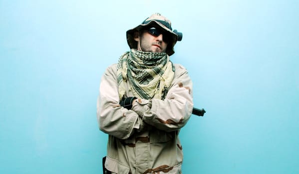 one soldier with the gun in the hands on a blue background