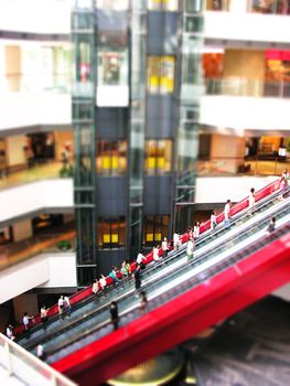 Red escalator in the middle of a shopping mall