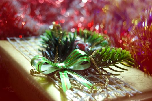 gift box with bow over holiday lights background