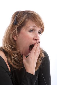 Female receptionist with headset yawning very wide