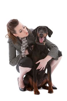 Young fashionable brunette with her doberman pincher on white background