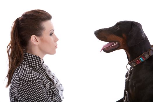 Beautiful brunette opposite a dobermann pincher