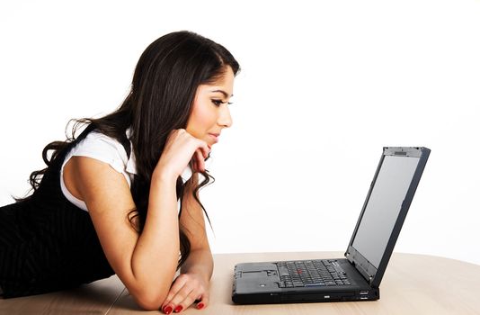 Beautiful girl working on computer, being very focussed