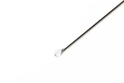 needle with liquid drop on white background