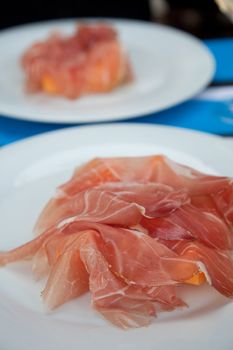 Fresh appetizer with prosciutto and melon on a plate