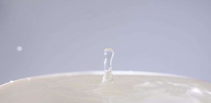 Lonely drop coming out from a can full of water