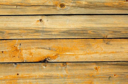 The old battered wall are covered with boards