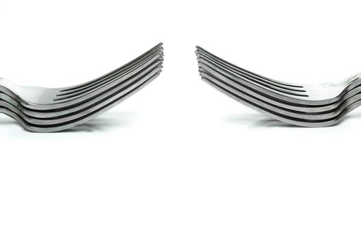 Silver table forks isolated against a white background