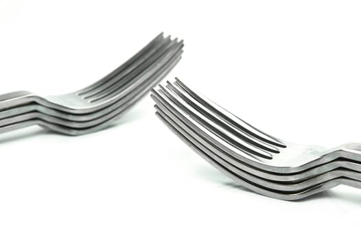 Silver table forks isolated against a white background