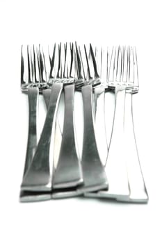 Silver table forks isolated against a white background