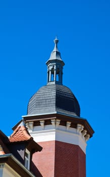 Wing peaked with two windows in the dark blue sky in an old city