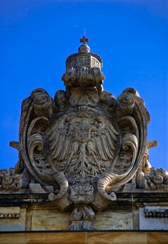 Stone eagle the arms on a building of court of a city of Leipzig against the blue summer sky