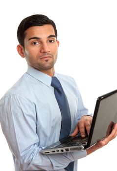 A businessman in blue pinstripe shirt holding a laptop computer.   White background.